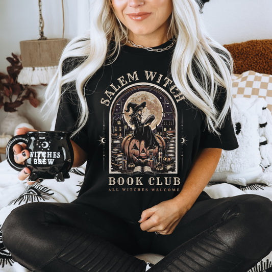 Salem Witch graphic tee with gothic witch reading by candlelight