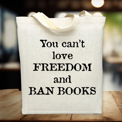 Tote bag with text 'You can't love freedom and ban books' on a blurred background